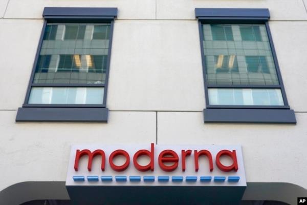 FILE - A sign for Moderna, Inc. hangs on its headquarters in Cambridge, Mass., Dec. 15, 2020.