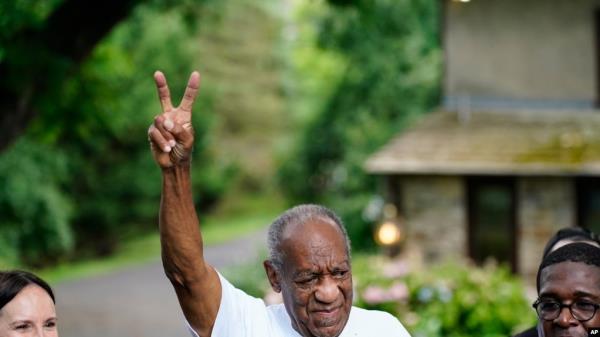 Bill Cosby gestures outside his home in Elkins Park, Pa., June 30, 2021, after being released from prison. Pennsylvania's highest court has overturned comedian Cosby's sex assault conviction.