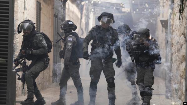 Palestinians shoot fireworks at Israeli police in the Old City of Jerusalem, April 17, 2022. 