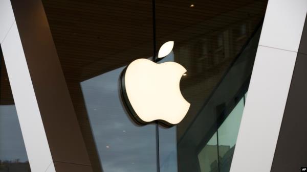 FILE - An Apple logo adorns the facade of the downtown Brooklyn Apple store in New York City, March 14, 2020. Workers at an Apple store in Oklahoma City, Oklahoma, voted to unio<em></em>nize in what observers say might give rise to a growing trend.