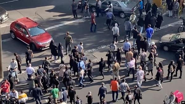 In this frame grab from video taken by an individual not employed by the Associated Press and obtained by the AP outside Iran shows people blocking an intersection during o<em></em>ngoing anti-government protests, in Tehran, Iran, Oct. 26, 2022. 