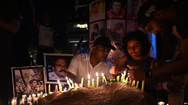 FILE - People hold a candlelight vigil for the victims and injured demo<em></em>nstrators during anti-government protests, in Colombo, July 16, 2022.