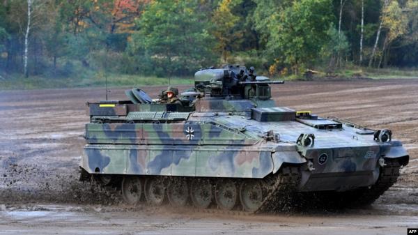 FILE - A Marder infantry fighting vehicle of the German armed forces Bundeswehr drives through the mud at a military training area in Munster, northern Germany, on Oct. 13, 2017. 