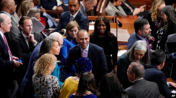 Rep. Hakeem Jeffries, center, talks to his Democratic colleagues in the House chamber in Washington, Jan. 5, 2023.