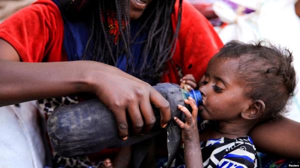 FILE - A severely malnourished child drinks from a bottle at a camp for internally displaced people in Afdera town, Afar region, Ethiopia, Feb. 23, 2022. 
