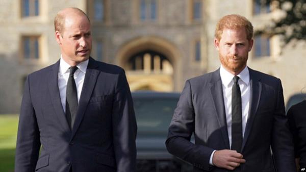 FILE - Britain's Prince William, Prince of Wales, left and Prince Harry walk to meet members of the public at Windsor Castle, in Windsor, England, Sept. 10, 2022. In his new book "Spare," Harry talks a<em></em>bout his struggles as well as his life as a royal and "spare" to the throne.